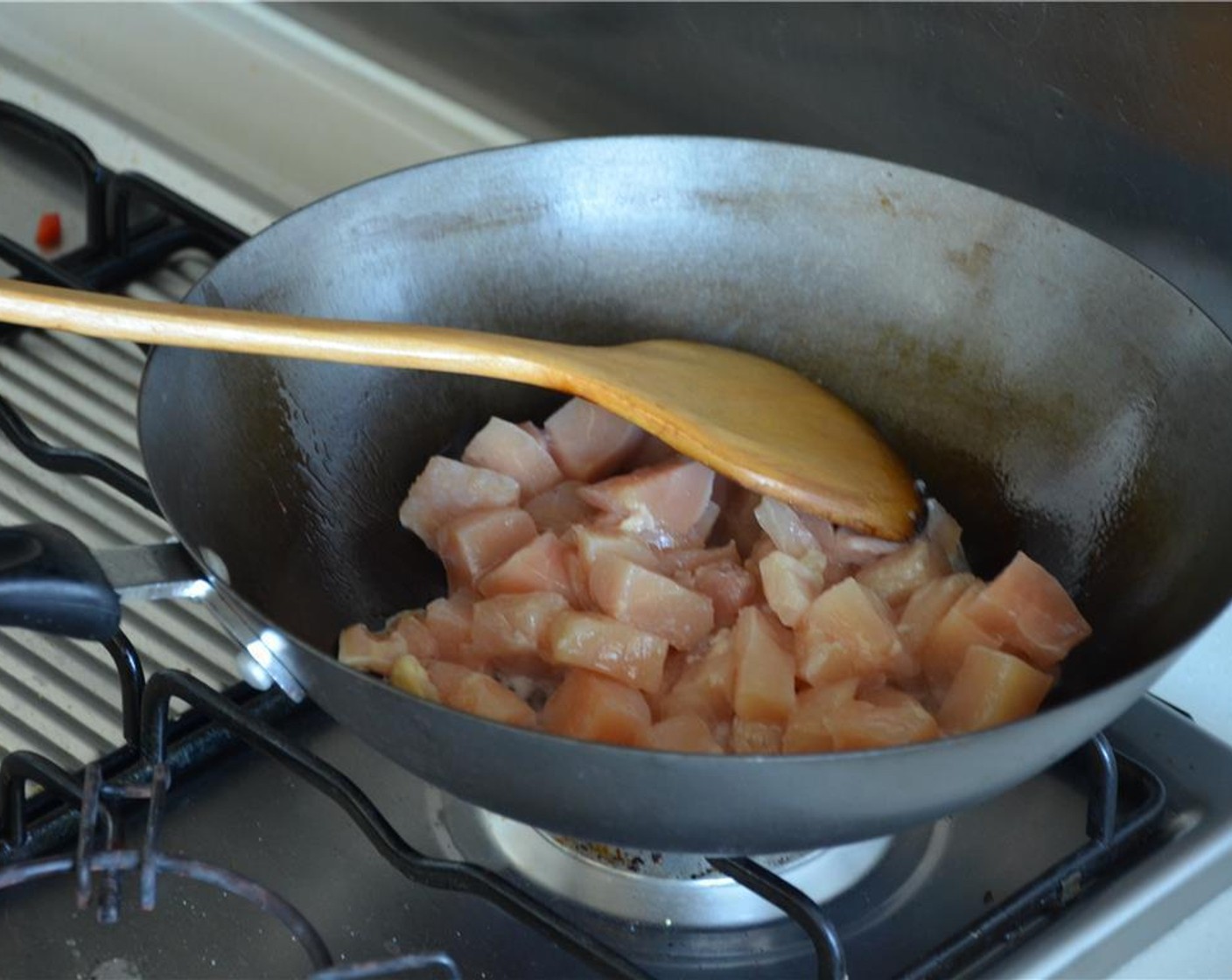 step 6 Heat Peanut Oil (1 Tbsp) in a wok and stir fry the chicken until they turn white.