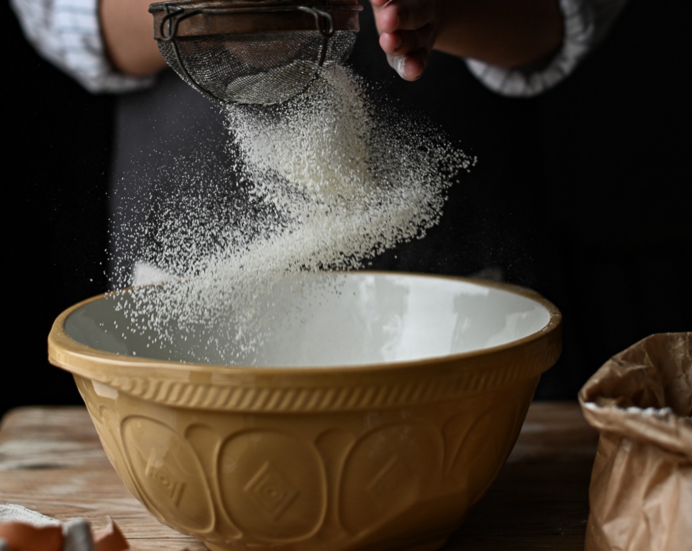 step 5 For the ravioli dough, sift the Type 00 Flour (3 cups) and add a good grind of salt. On a flat surface, turn out the flour and make a well in the center.