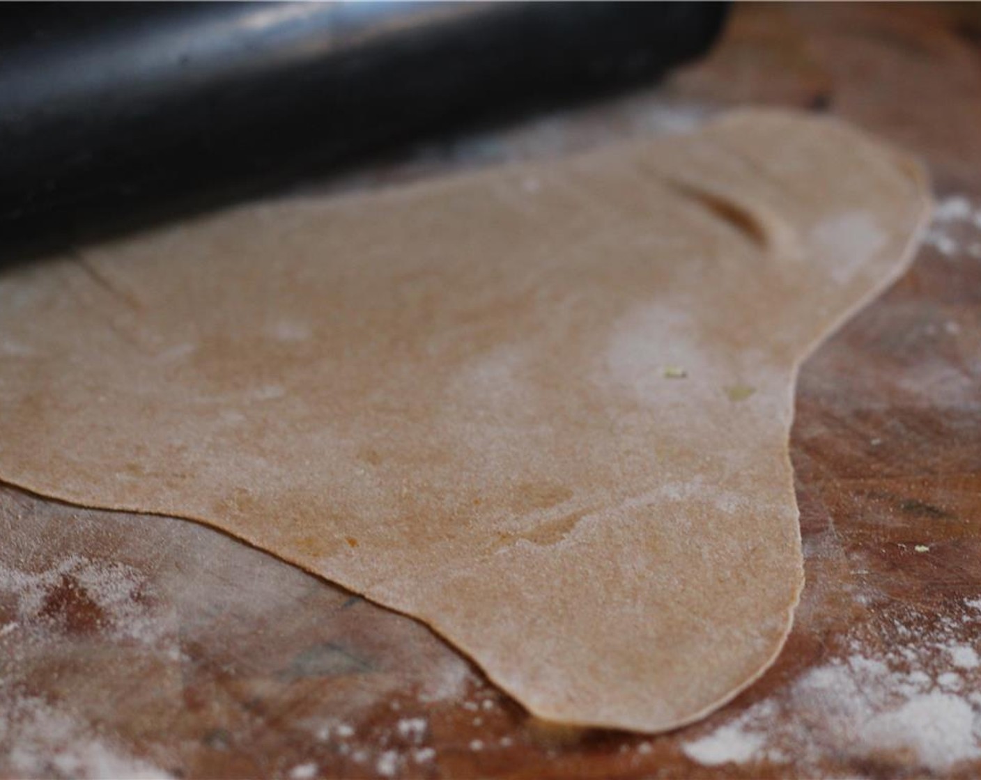 step 10 Sprinkle a countertop with All-Purpose Flour (to taste) and place one piece of dough in the middle. Cover the ball with flour on all sides so that it doesn't stick to the surface, then gently roll it out with a rolling pin until it's thin and flat, about 1/8" thick.