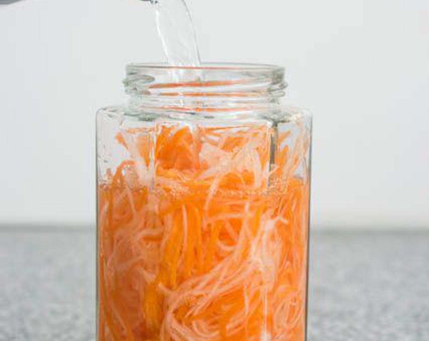 step 1 Make the pickled carrot and radish: Place the Carrot (1 cup) and Daikon Radish (1 cup) in a jar. Fill the jar with Distilled White Vinegar (1 cup), Water (3/4 cup), and Granulated Sugar (1/4 cup).
