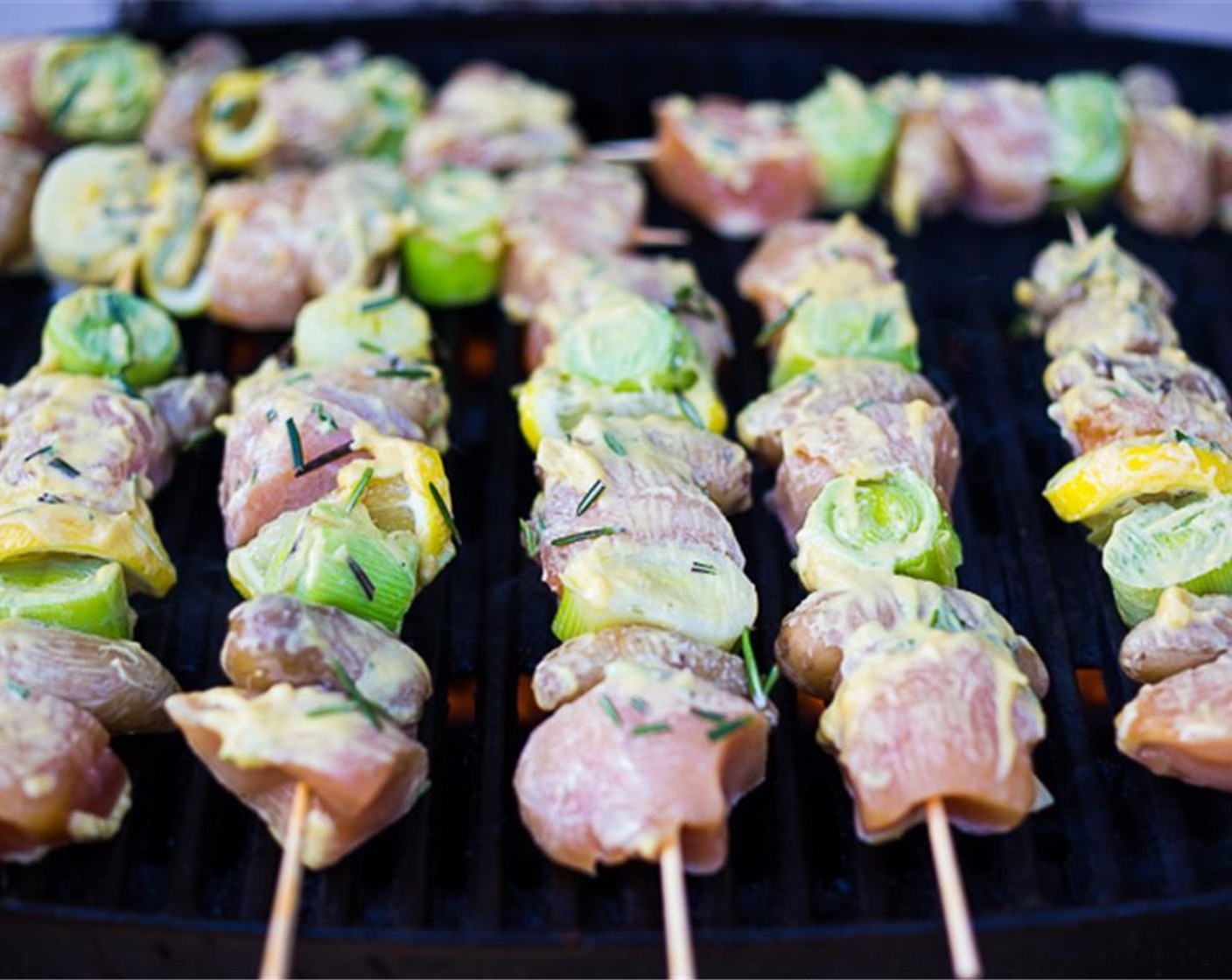 step 9 On medium high grill , grease with spray oil, and place skewers on the grill. Cover and let cook about 4 minutes, or until there are good grill marks.