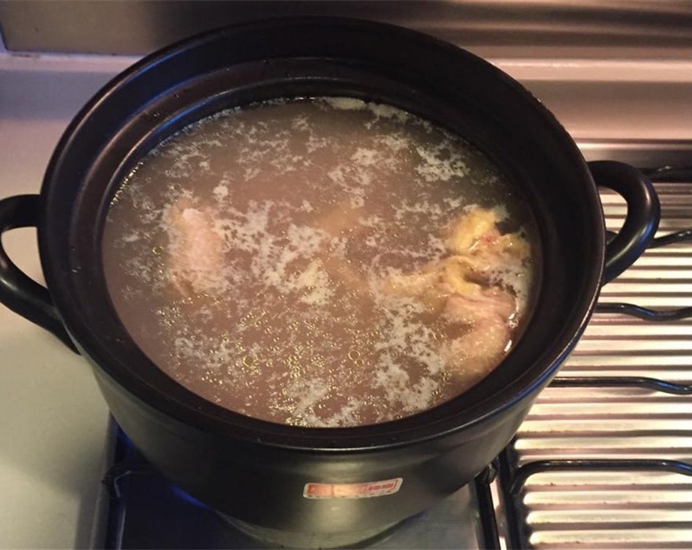 step 3 Chop the Whole Chicken (1) into manageable pieces. In a pot, add chicken, Cooking Wine (4 Tbsp) and enough water to cover the chicken. Cook until the water starts to boil, strain the chicken and rinse under water.