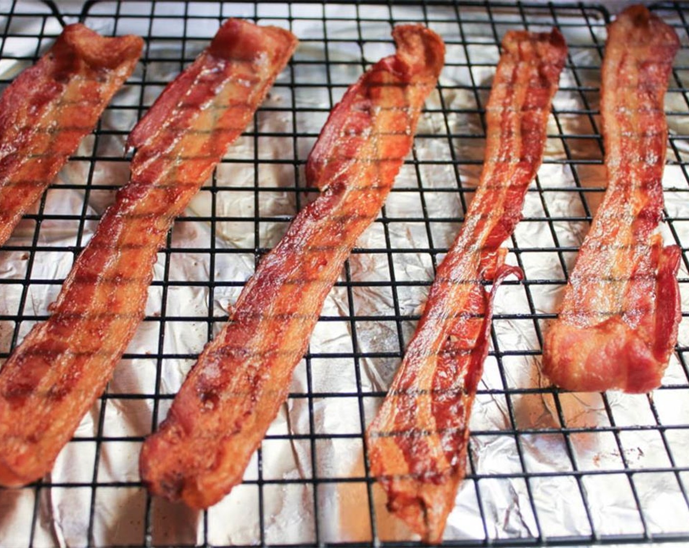 step 5 Place the Bacon (6 slices) on a rack over a foil lined baking sheet. Bake for 25 minutes until brown and crispy. When cool enough to handle, crumble the bacon and set aside until ready to use.