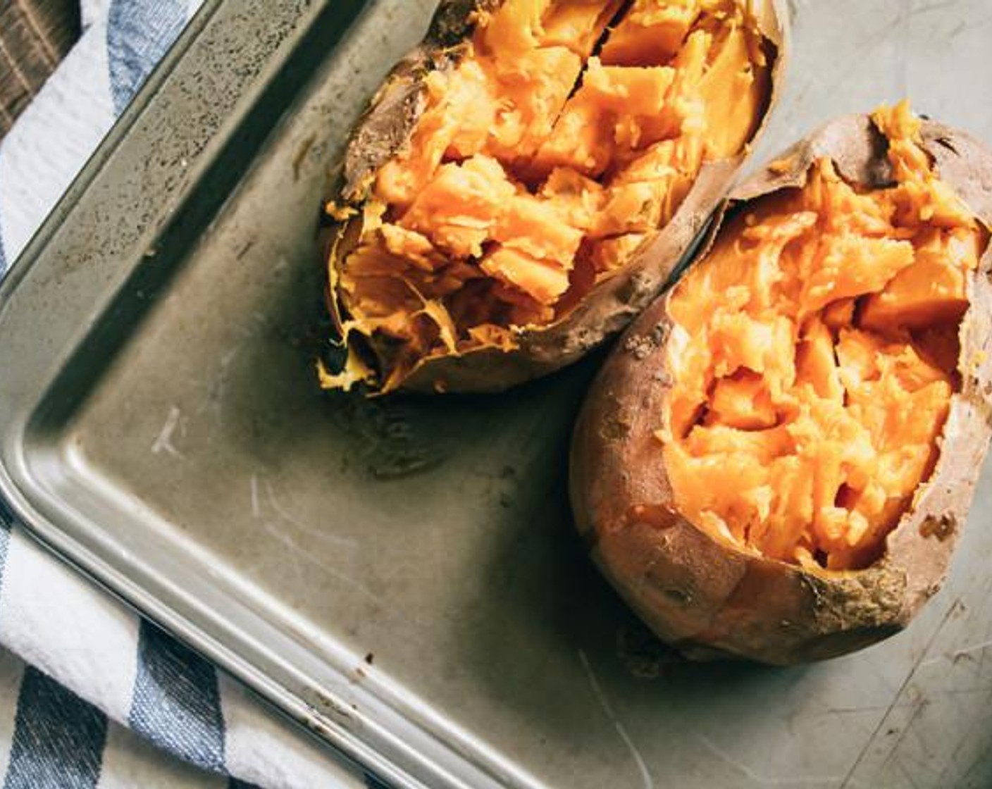 step 6 Once the sweet potatoes are cooked, allow to cool for a few minutes, then cut off tops and scoop out the cooked flesh of each potato, add to a large bowl. Leave the skin of the potatoes intact along with a thin layer of potato to help hold skins together.