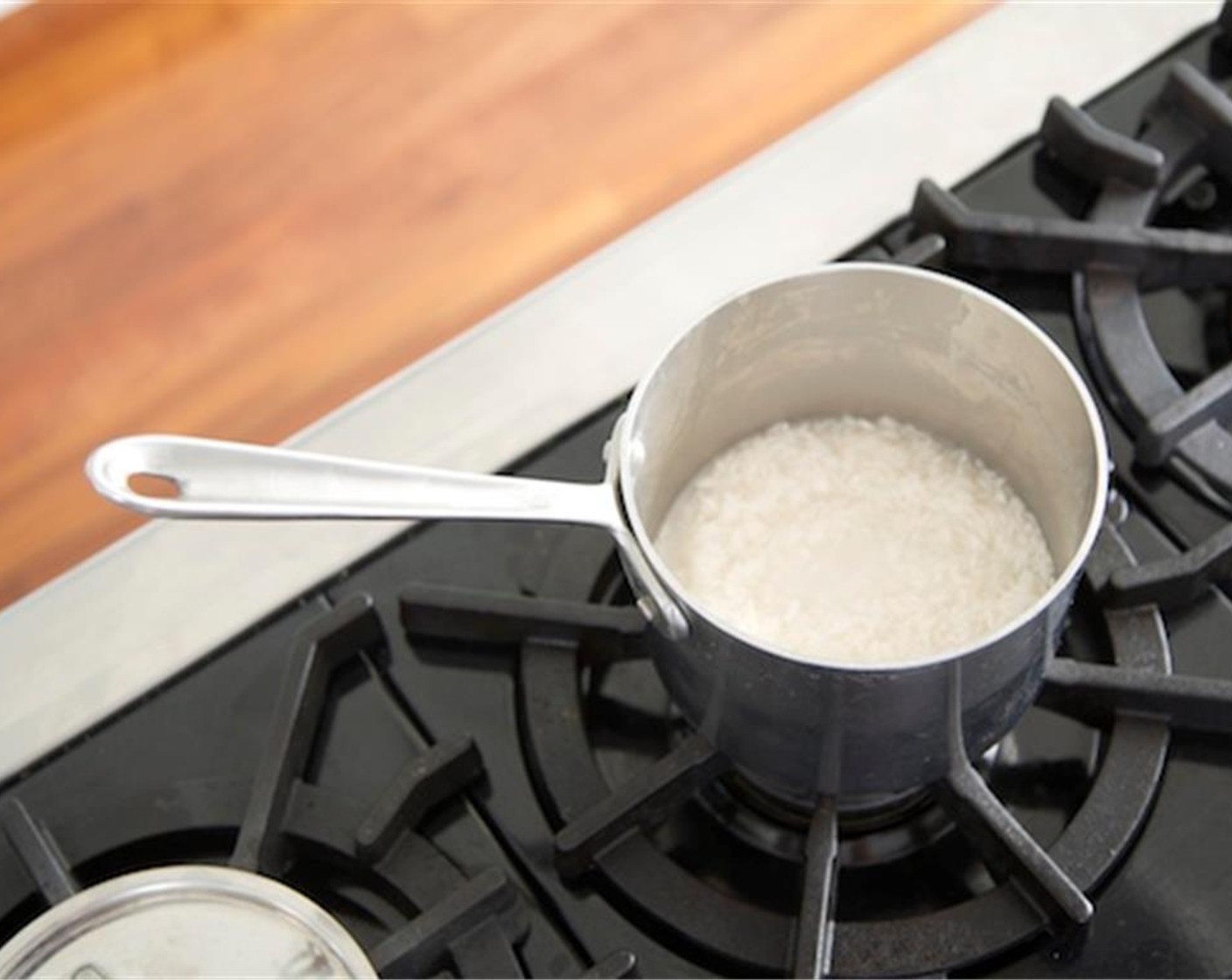 step 1 In a small saucepan, heat Jasmine Rice (2/3 cup) with one cup of cold water over high heat and stir. Bring to a boil, lower to a simmer, cover, and cook on low for fifteen minutes or until all water has been absorbed. Fluff rice with a fork and keep covered.