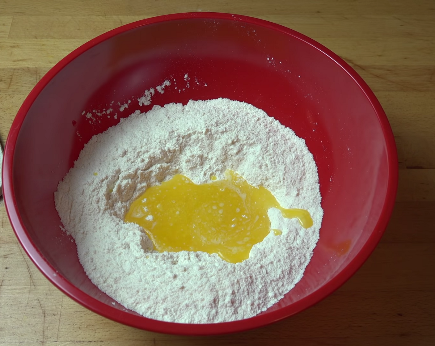 step 3 Make a hole in the center of the dry ingredients, and pour in Unsalted Butter (3/4 cup). Using a wooden spoon, mix together until you get a soft dough.