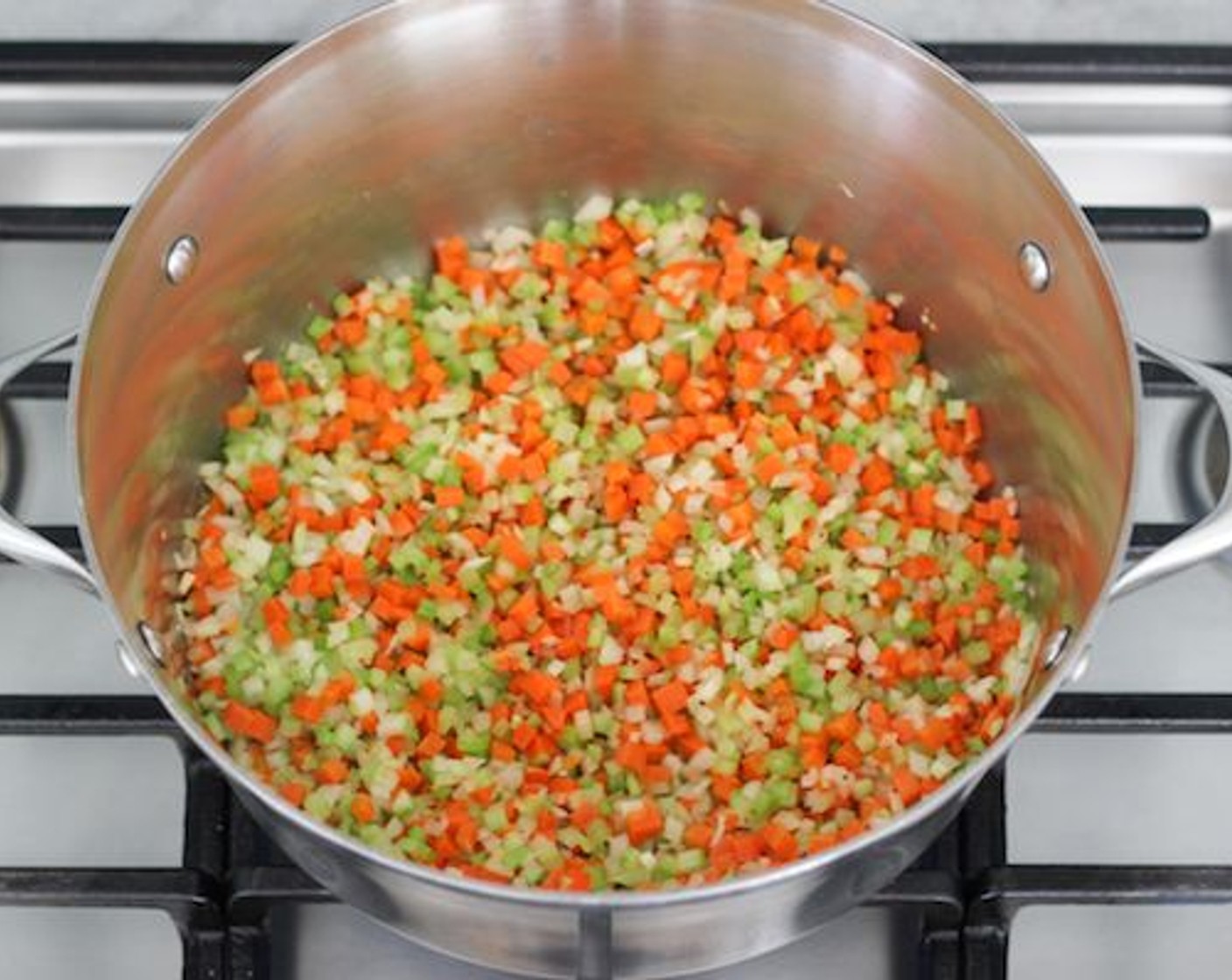 step 1 In a dutch oven or a large pot, heat the Butter (1 Tbsp) or oil until hot, adding the Onion (1), Carrots (2), Celery (2 stalks), and Garlic (2 cloves). Season with salt and ground black pepper. Cook for about 5 minutes on medium heat, until the vegetables are softened.