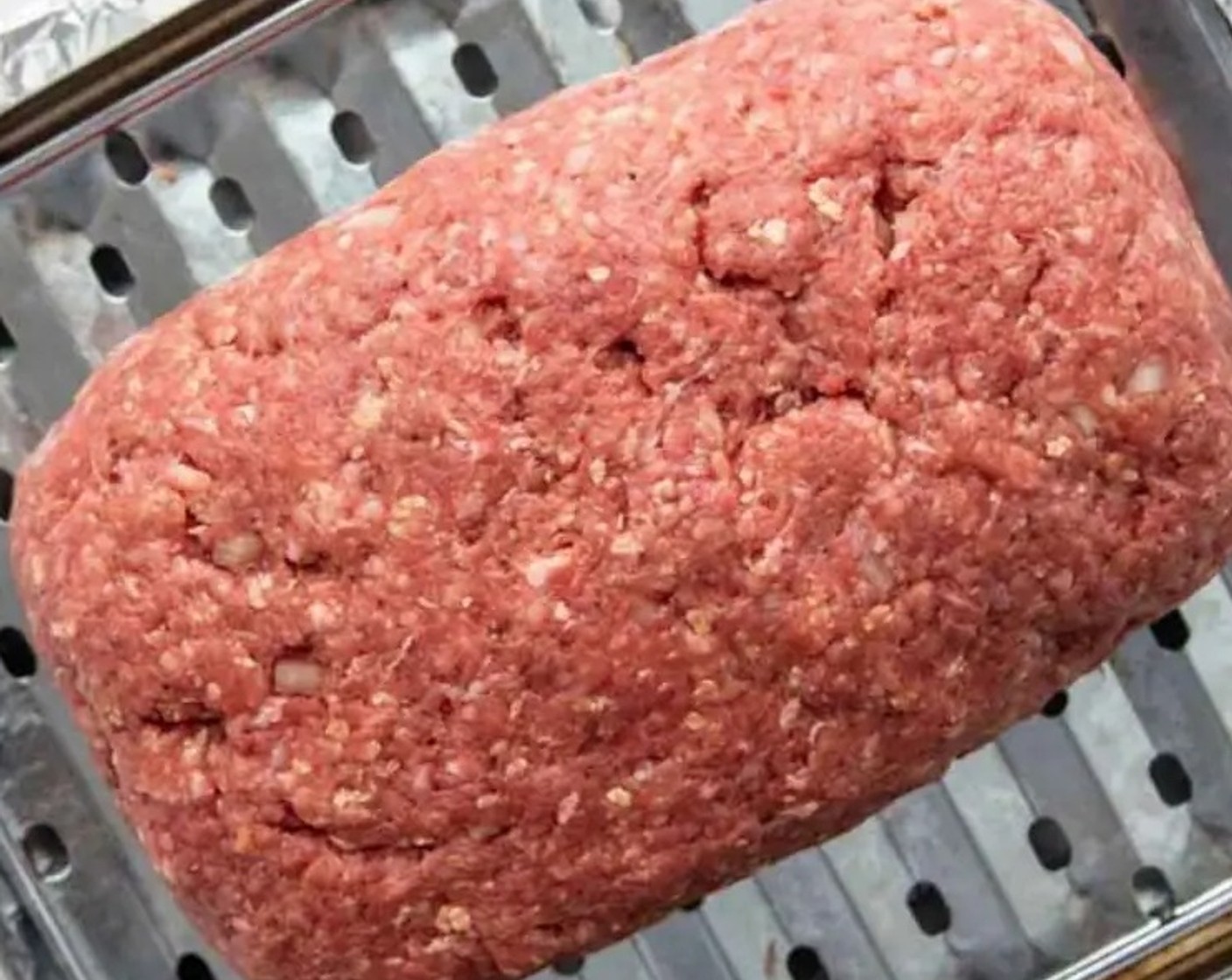 step 4 Shape the meatloaf into a uniform loaf and place it on the prepared pan. Brush 1/3 of the meatloaf glaze over the top and sides.