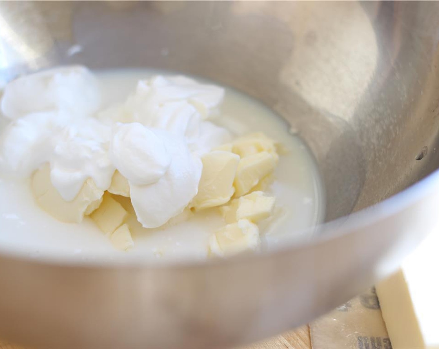 step 3 In a large mixing bowl, combine the Unsalted Butter (1/3 cup), Eggs (2), Sour Cream (1/2 cup), and Milk (1/2 cup).