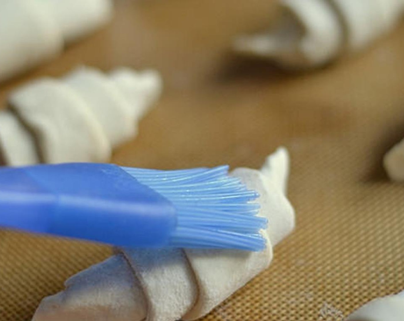 step 7 Arrange croissants on a baking sheet and brush the tops with a little milk to give them a nice browned color as they bake.