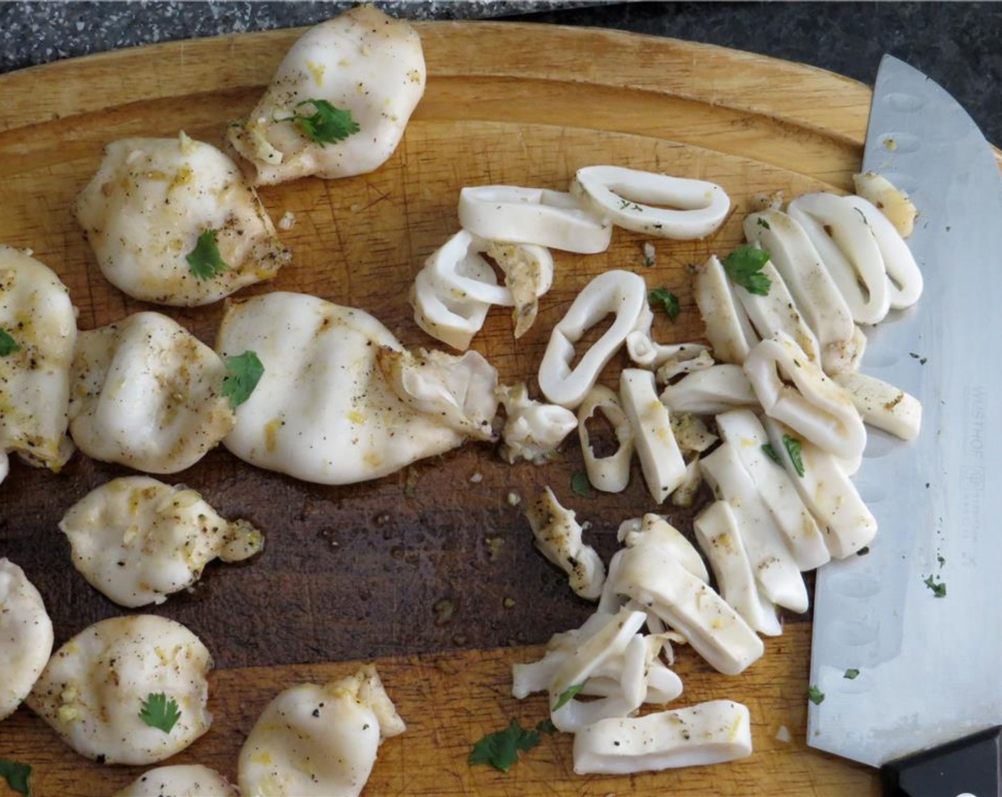 step 6 Transfer toasts to a cutting board. Gently rub toasts on one side with peeled garlic. Discard any remaining garlic. Grill fresh squid tubes for 1 to 2 minutes per side, turning once. Transfer to a cutting board.