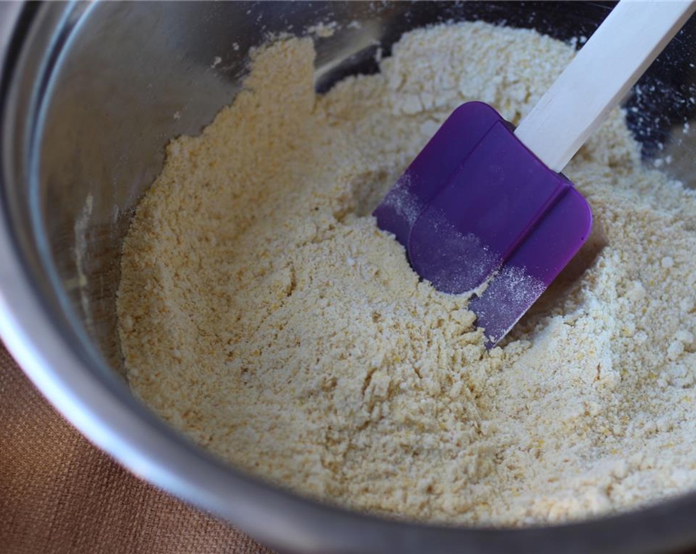 step 2 Mix the dry ingredients: Corn Flour (1 cup), Cornmeal (1 cup) and Baking Powder (1/2 Tbsp). In a separate bowl, mix the wet ingredients: Canola Oil (1/4 cup), Maple Syrup (2 Tbsp), and Non-Dairy Milk (1 cup).