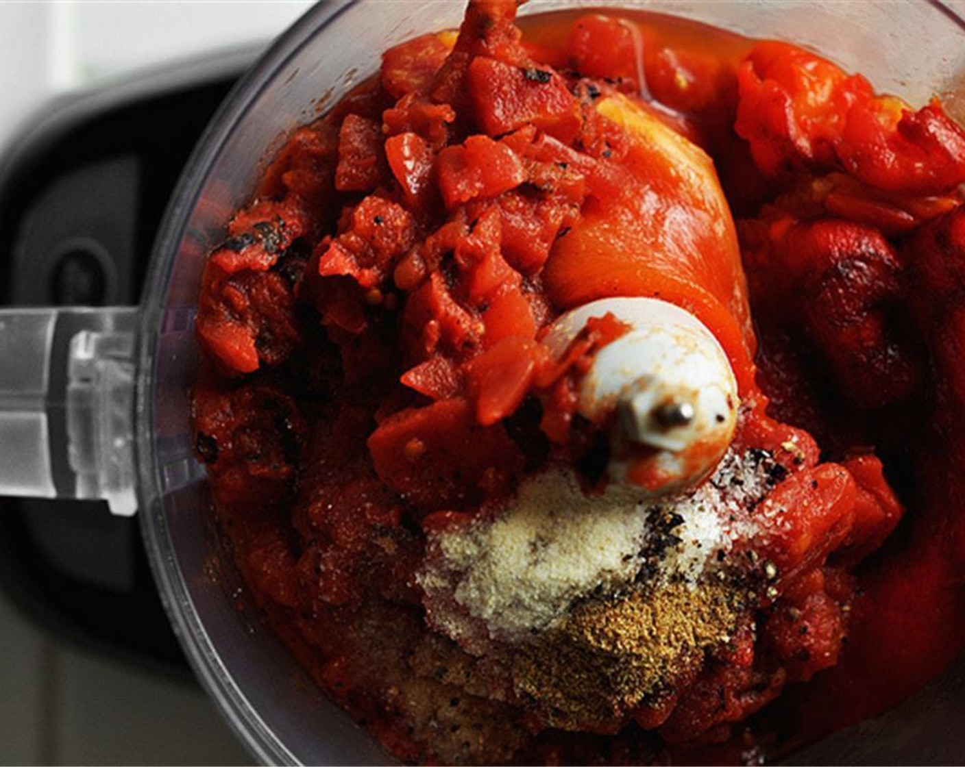 step 6 In a food processor or blender, combine the roasted peppers, Canned Fire Roasted Diced Tomatoes (1 2/3 cups), Salt (1 tsp), Freshly Ground Black Pepper (1 tsp), McCormick® Garlic Powder (1/2 tsp), and Ground Cumin (1/2 tsp).