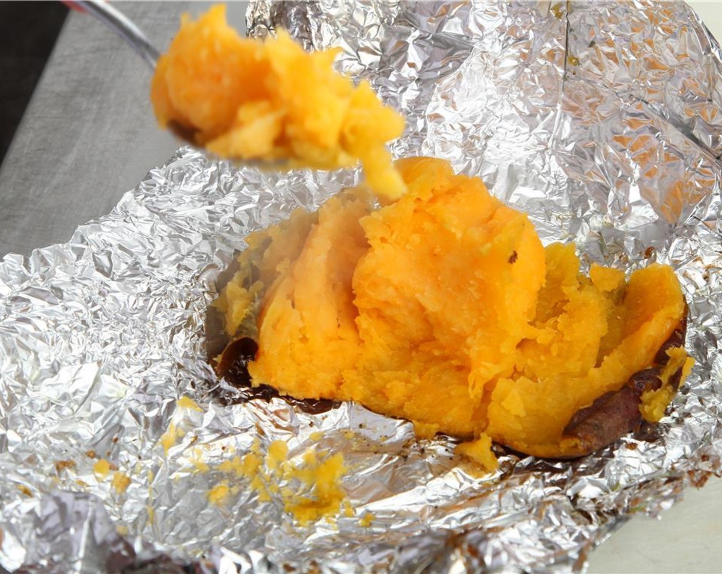 step 20 When the sweet potato is ready, very carefully remove foil and scoop out sweet potato flesh into a blender.