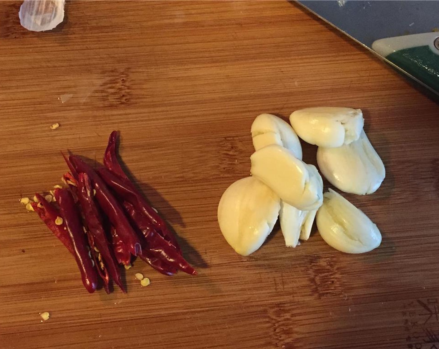 step 4 Slice the Dried Chili Peppers (3) in half lengthwise. Take the skin off the Garlic (3 cloves).