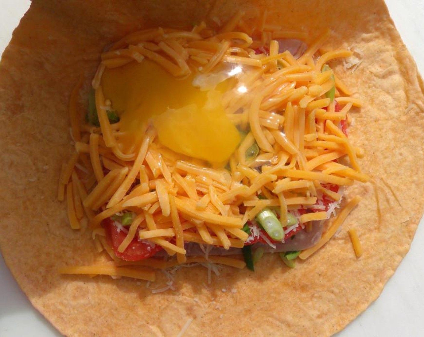 step 5 Top with Eggland's Best Classic Egg (1) and fold the wrap into a pouch with the seams on top. Add another Tortilla (1) and fold into a pouch with seams on the bottom.