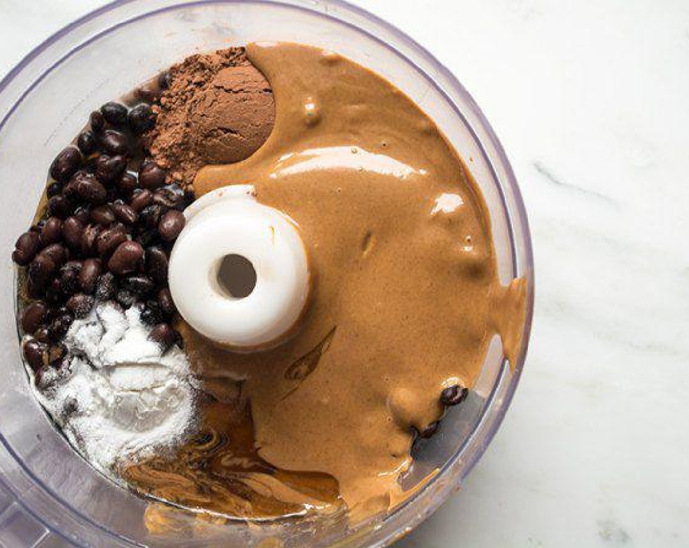 step 2 Combine Canned Black Beans (2 1/3 cups), Unsweetened Cocoa Powder (2 Tbsp), Vanilla Extract (1 Tbsp), Peanut Butter (2/3 cup), Honey (1/3 cup), and Baking Powder (1 tsp) in the container of a food processor. Process mixture until very smooth.