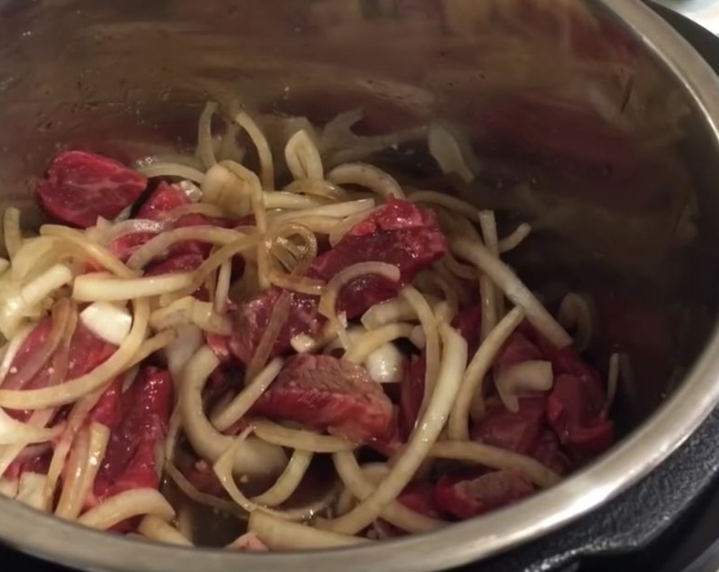 step 2 Once warm, add White Onion (1), Garlic (2 Tbsp), Beef Chuck (1.5 lb), Sweet Chili Sauce (1/3 cup), Fish Sauce (2 tsp), Rice Vinegar (2 Tbsp), Brown Sugar (1/3 cup), Beef Stock (1 1/4 cups), and Soy Sauce (4 Tbsp). Stir to combine.