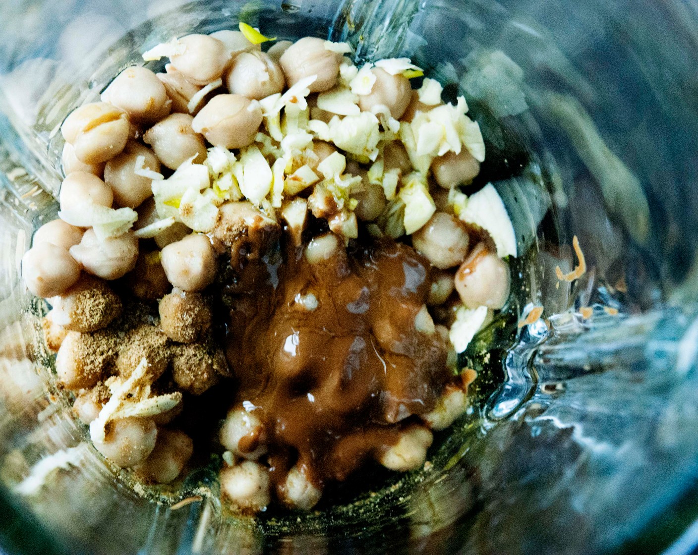 step 2 Place chickpeas, Tahini (1 Tbsp), Ground Cumin (1 tsp), 1 Tbsp of Lemon (1), Salt (1/2 tsp), and Garlic (2 cloves) in a blender.