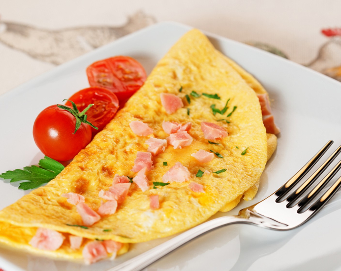 step 5 When the center is still slightly runny, add the ham, onions, and peppers to the center and carefully fold the omelet in half. Cook on one side for one minute, then flip to the other side until the center is cooked through.
