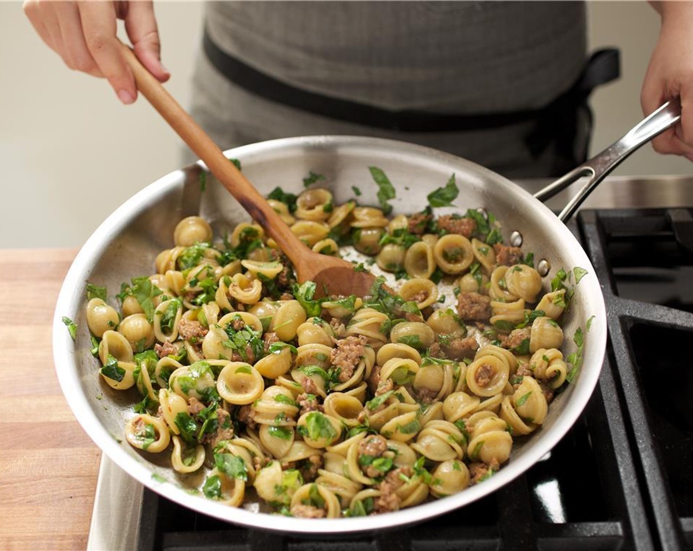 step 8 Add arugula to the orecchiette pasta mixture and cook until arugula slightly wilts. Remove from heat and keep warm for plating.