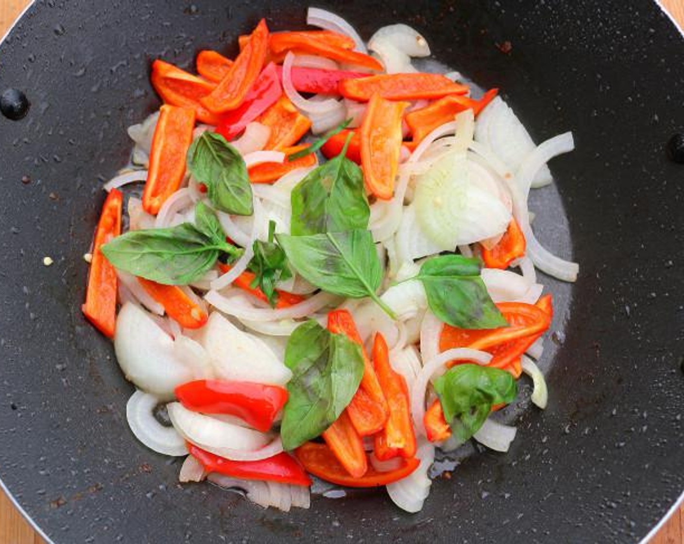 step 6 In the remaining 1 tablespoon peanut oil, saute White Onion (1), Red Bell Pepper (1) and Fresh Basil Leaves (10) for 1 minute.