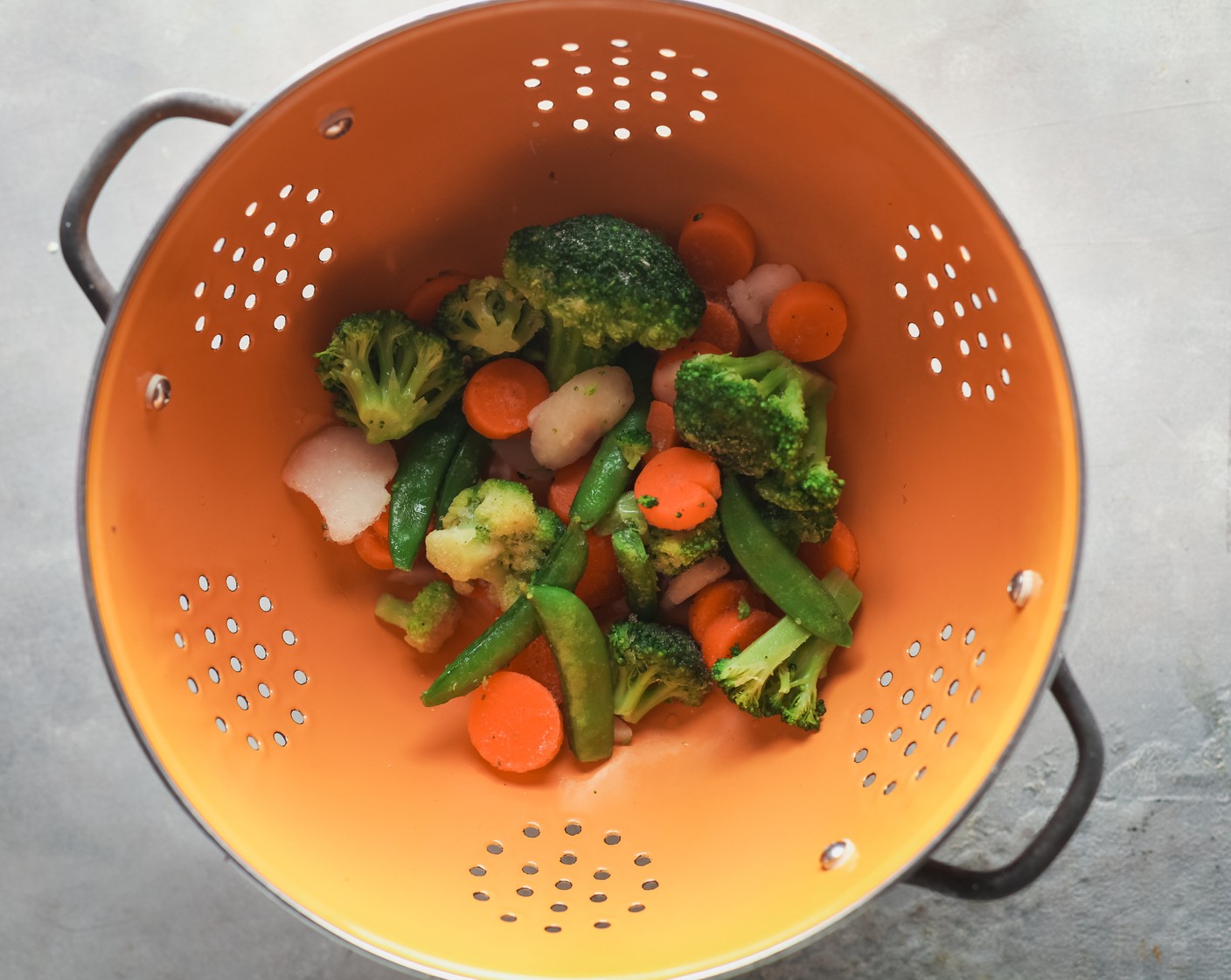 step 3 Place a colander in the sink. Add the Frozen Mixed Vegetables (1 bag) to the colander.