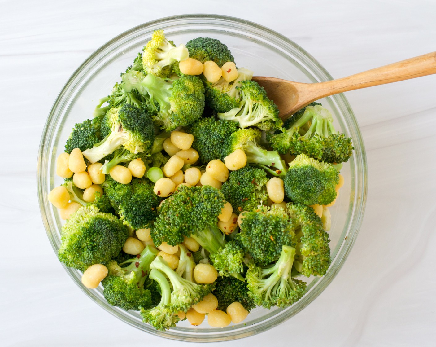 step 2 Toss the Gnocchi (1 pckg), Broccoli (1 head), Garlic (2 cloves), Crushed Red Pepper Flakes (1/4 tsp) with the Extra-Virgin Olive Oil (4 Tbsp) in a large bowl.