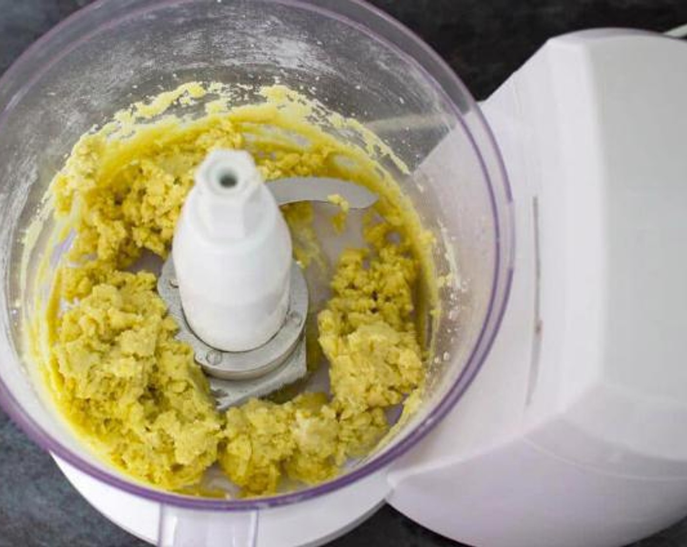 step 2 Add a little Water (3 1/3 Tbsp) at a time and pulse until it comes together to form a dough.