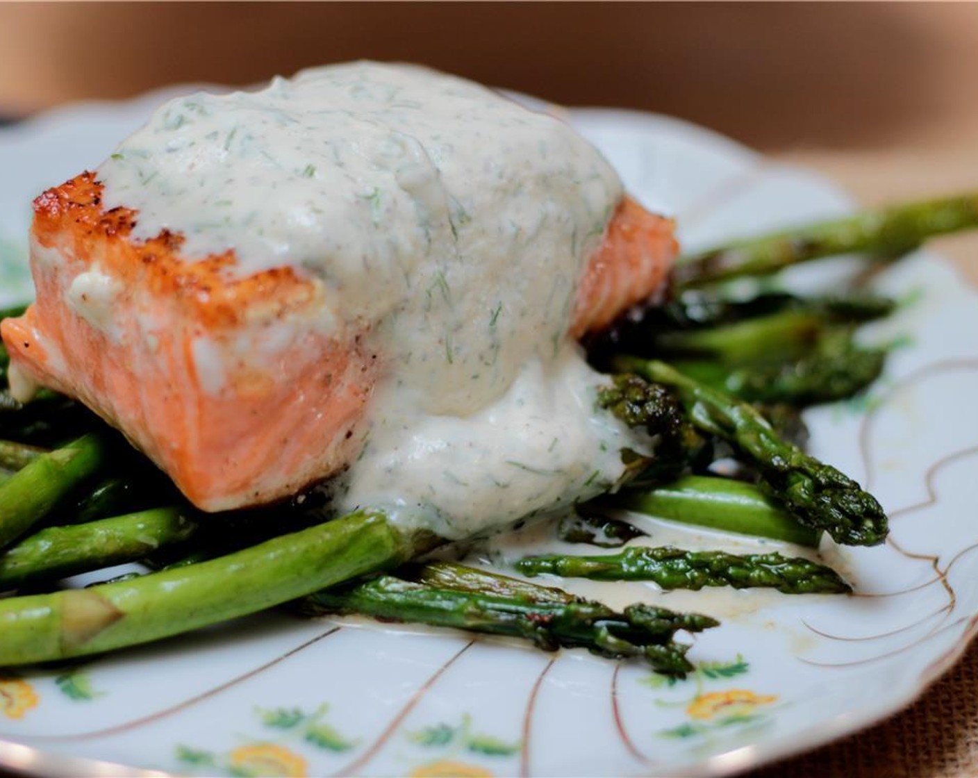 step 9 To serve, arrange asparagus in the center of each plate, set a salmon fillet, skin side down, on top, and spoon dill sauce over the salmon.