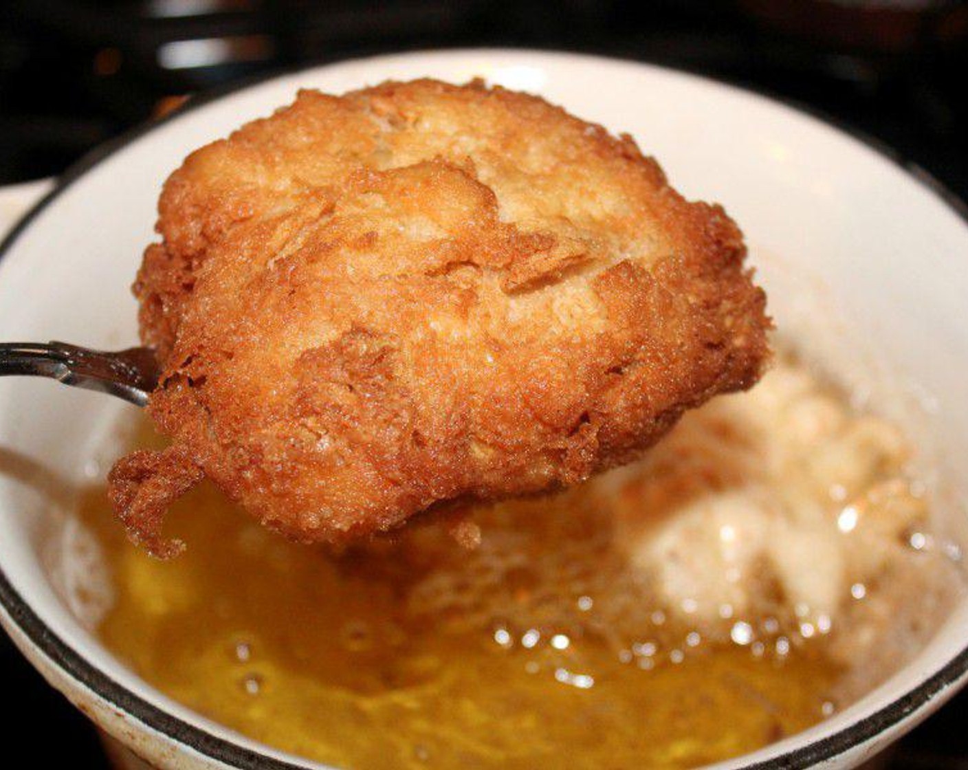 step 4 Scoop a generous spoonful of the batter, and drop it directly into the hot oil, and fry until golden on all sides, and firm.