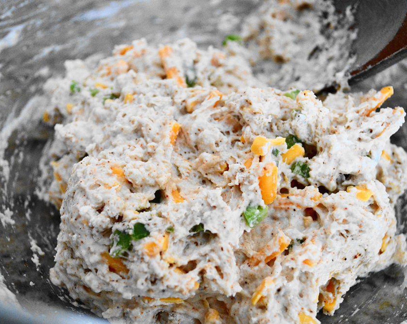 step 2 In a large mixing bowl whisk together the All-Purpose Flour (1 cup), Baking Powder (1/2 Tbsp), Smoked Paprika (1/4 tsp), Chili Powder (1/4 tsp), and Salt (1 pinch) to aerate the mixture. Then add in the Shredded Sharp Cheddar Cheese (1/2 cup), Jalapeño Pepper (1), and Almond Milk (2/3 cup) and stir it all just until it comes together into a soft dough.