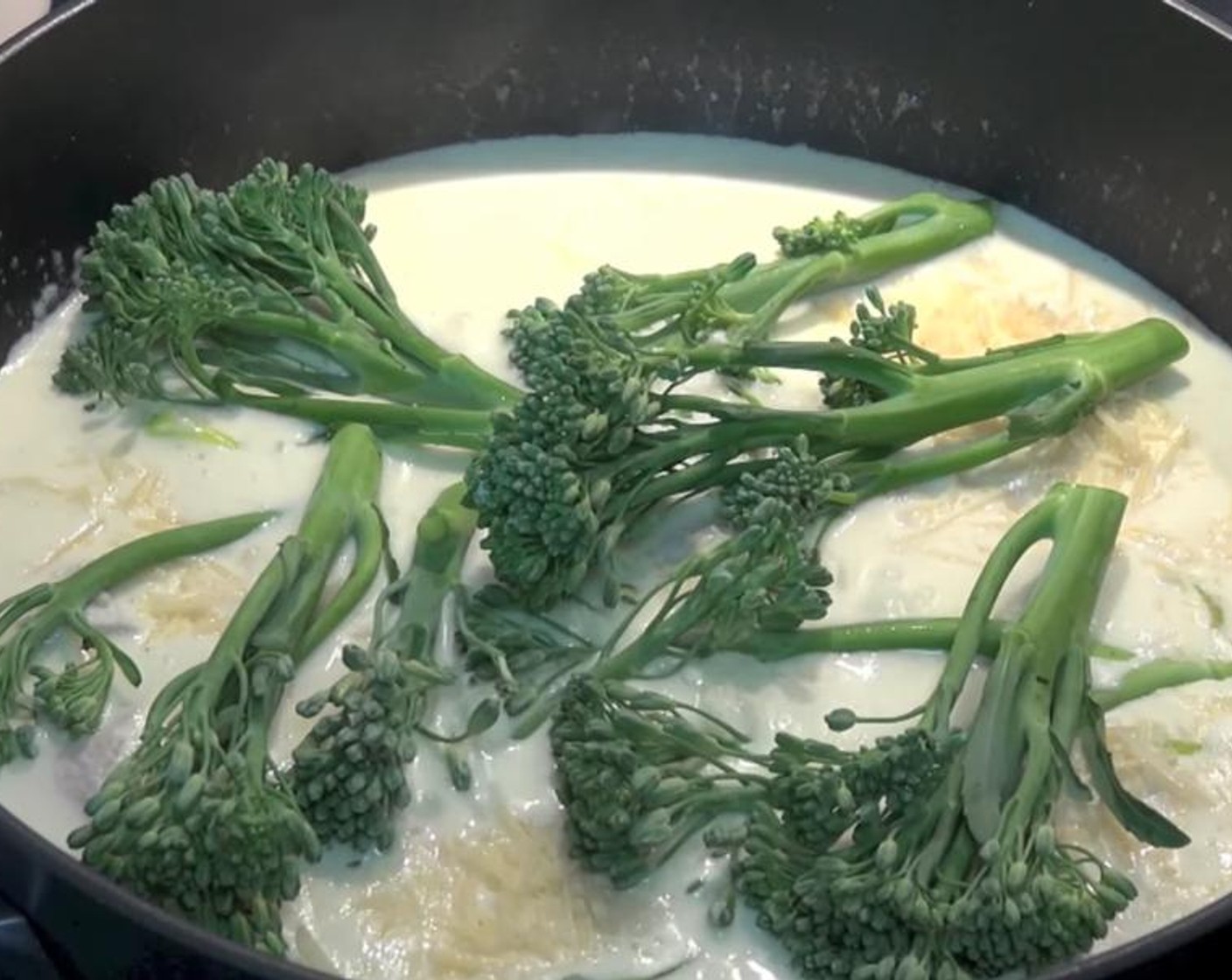 step 5 Once boiling, reduce the temperature to low. Add in Parmesan Cheese (1/2 cup) and Broccolini (1 bunch). Gently stir for a few minutes until broccolini is tender.