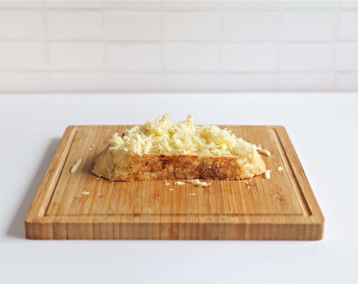 step 5 Place butter side down on the cutting board. Top unbuttered side of the bread with grated Gruyère Cheese (1/3 cup).
