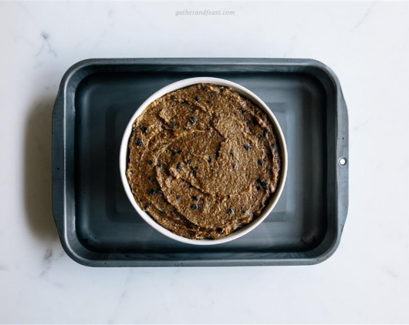 step 8 Place the pudding bowl into a deep baking tray, then pour in hot water until it reaches ½ to ¾ of the way up the roasting tray.