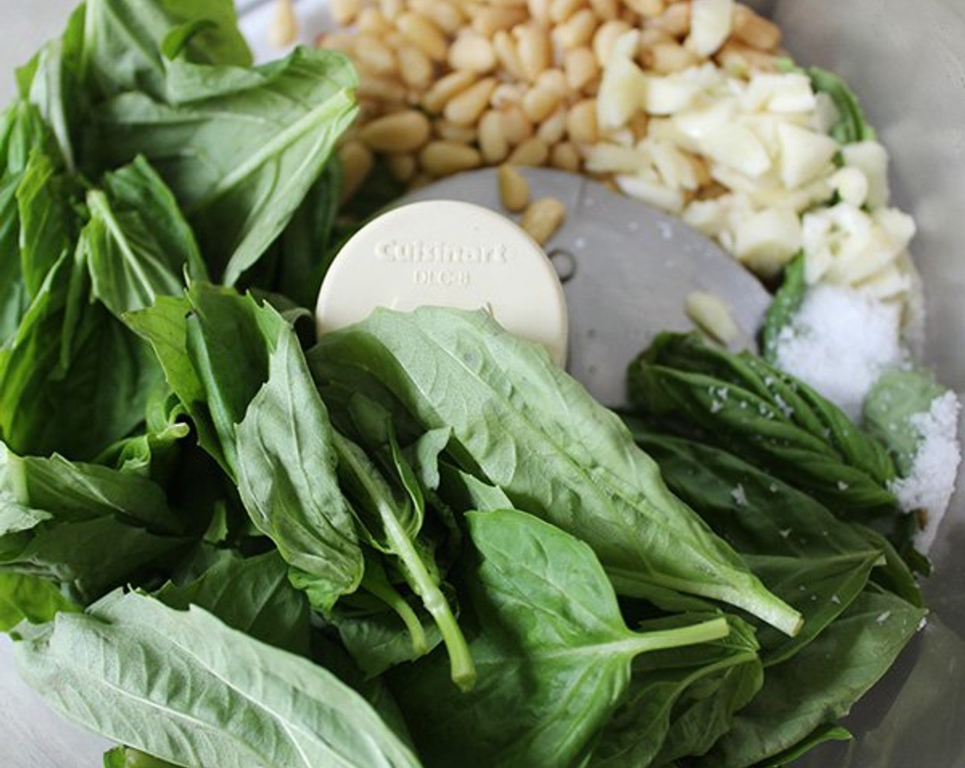 step 4 Add the Fresh Basil Leaves (2 cups), Fresh Mint Leaves (1/2 cup), 3 Tbsp of the Lemon Juice (2), and Kosher Salt (1/2 tsp), pulse until the herbs are coarsely chopped.