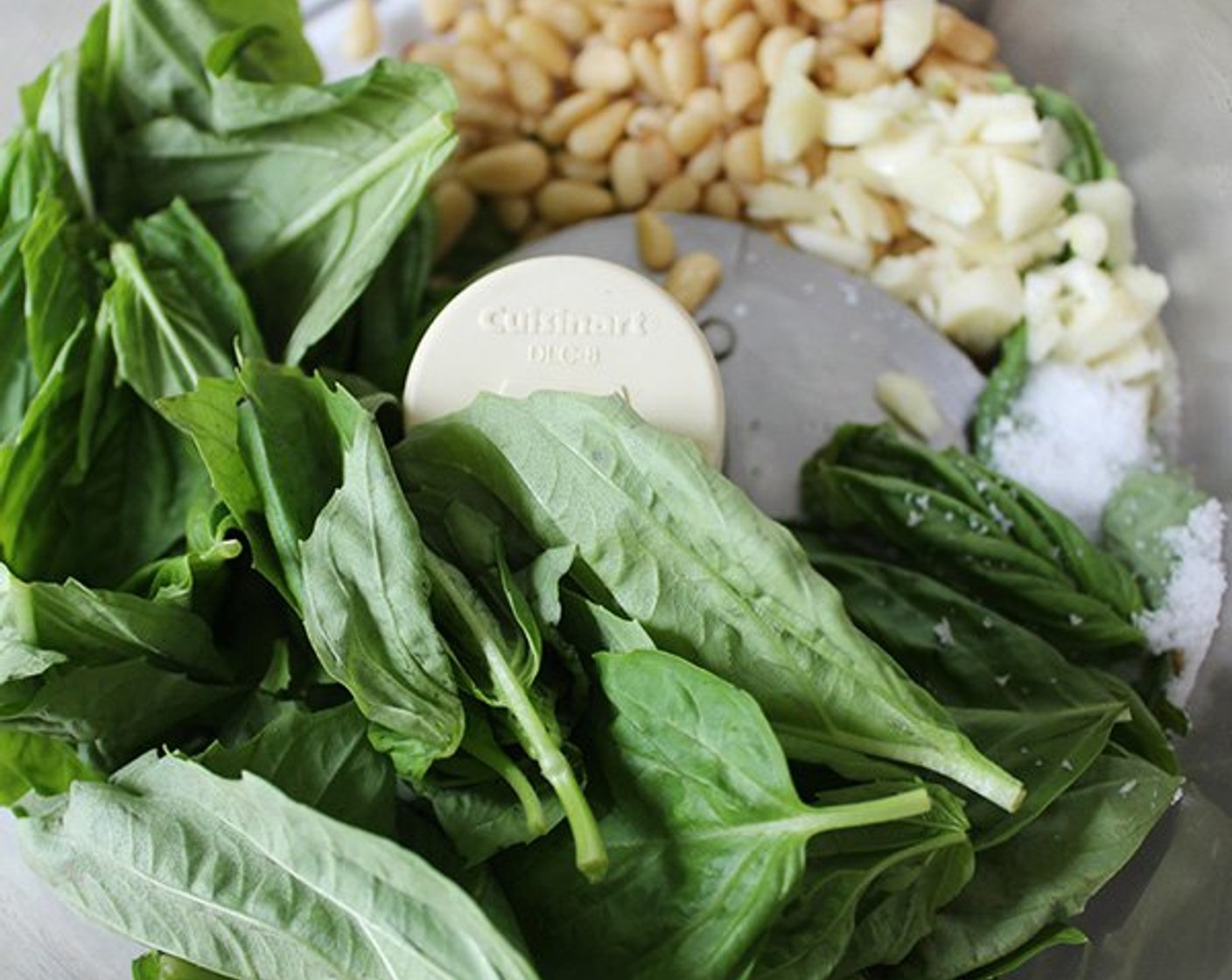 step 4 Add the Fresh Basil Leaves (2 cups), Fresh Mint Leaves (1/2 cup), 3 Tbsp of the Lemons (2), and Kosher Salt (1/2 tsp), pulse until the herbs are coarsely chopped.