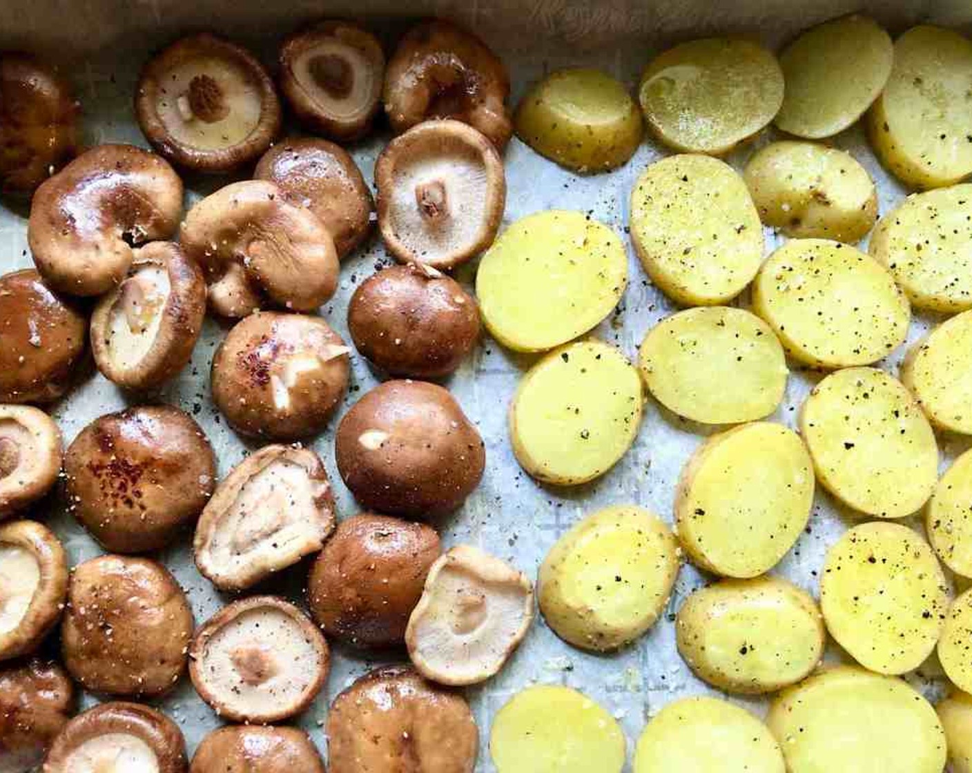 step 7 Add the prepared mushrooms to the other end of the baking sheet. Roast for 15 minutes more or until the potatoes are tender and slightly caramelized.