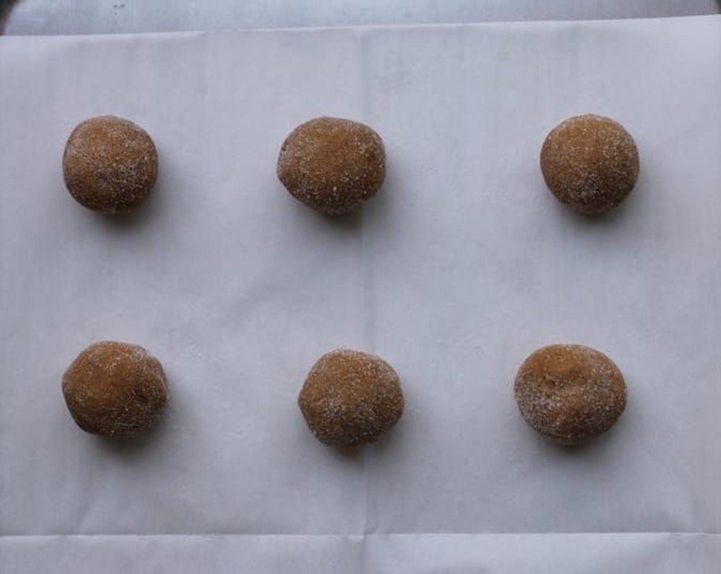 step 5 Place balls about 2-1/2 inches apart on an ungreased cookie sheet that has been lined with parchment paper.
