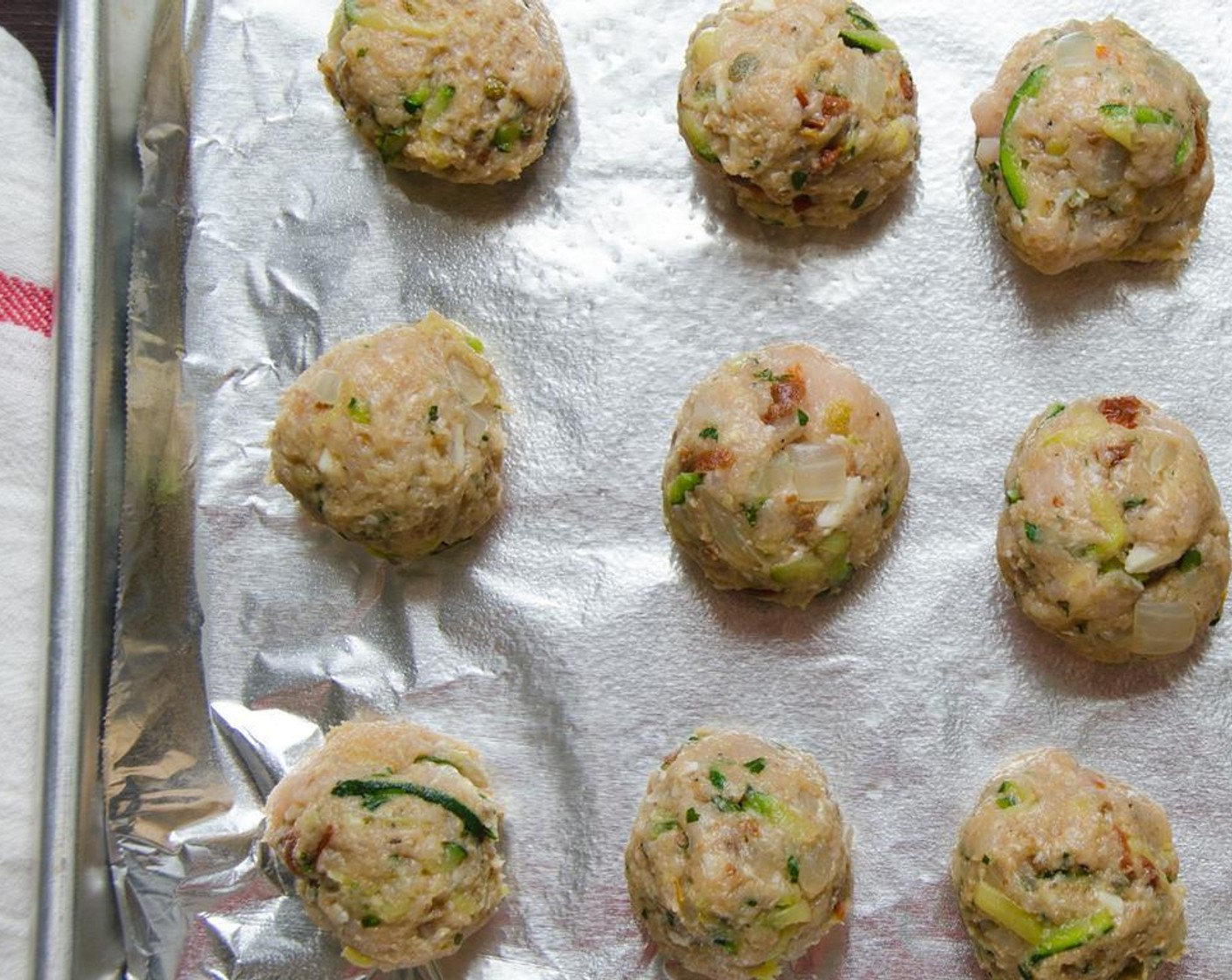 step 10 Scoop out a tablespoon of turkey mixture and roll it between your hands to form a meatball. Place the meatballs on the cookie sheet about 1-inch apart.