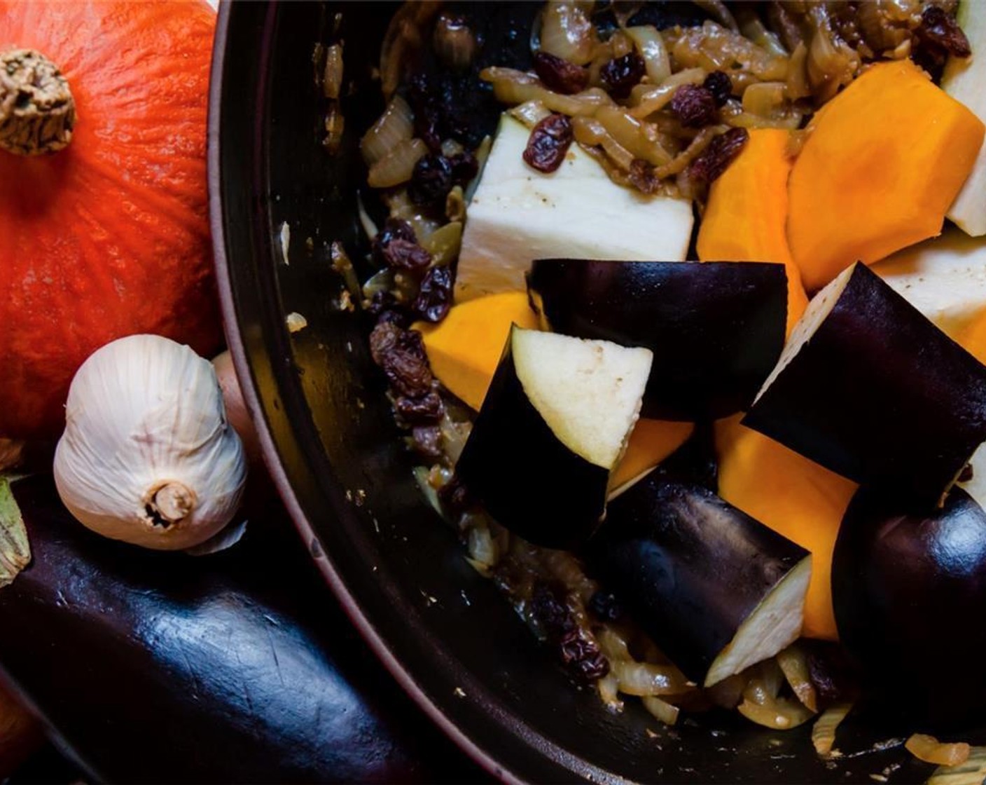 step 4 Add the Garlic (4 cloves), Eggplants (2), Pumpkins (2), Ground Turmeric (1 tsp), Ground Ginger (1/2 tsp), Salt (1 tsp), Ground Black Pepper (1/4 tsp), Water (2 cups), and Raisins (1 cup). Cover the casserole with a lid.