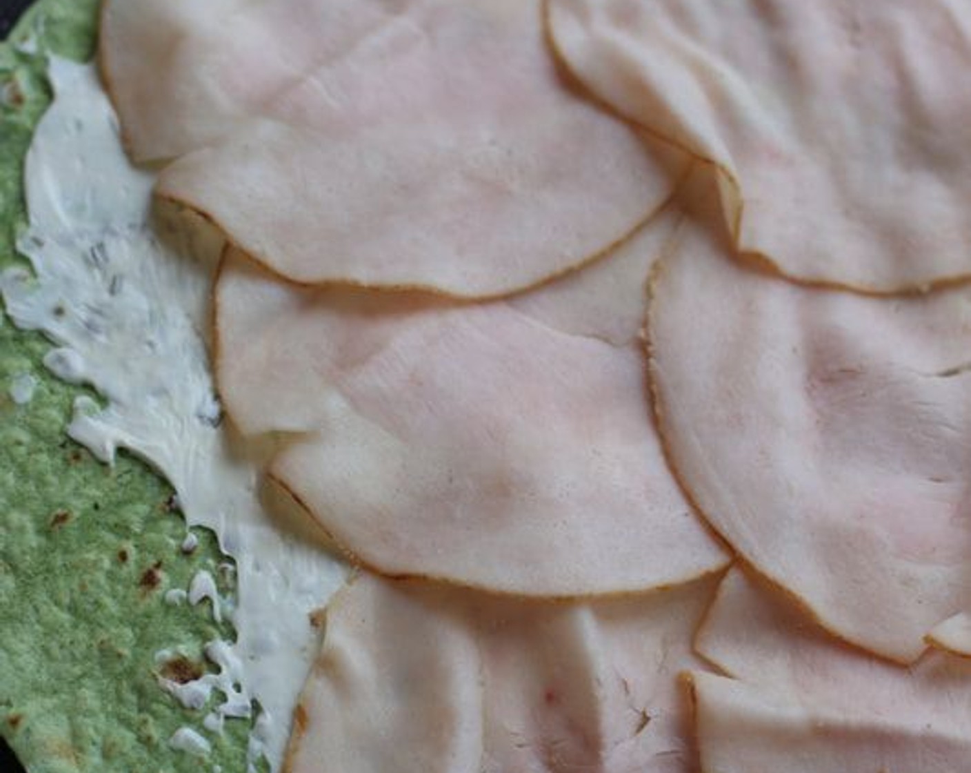 step 2 Layer 4 slices of Deli Turkey (16 slices) on top of cream cheese layer.