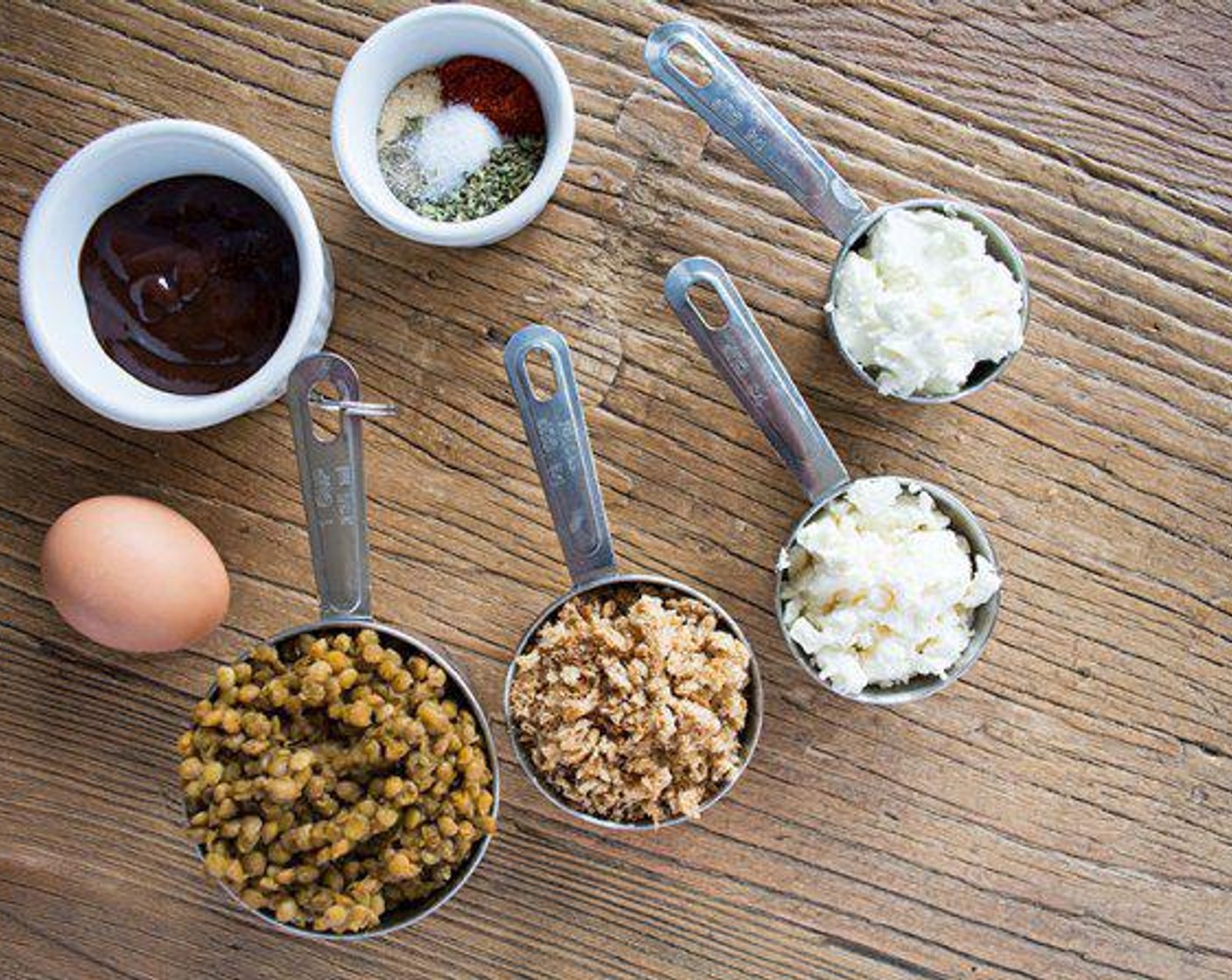 step 2 In a large bowl combine mashed lentils, Breadcrumbs (1/2 cup), Eggland's Best Classic Egg (1), Feta Cheese (1/2 cup), Goat Cheese (4 Tbsp), Simply Organic Garlic Powder (1 tsp), Dried Oregano (1 tsp), Paprika (1/2 tsp), Sea Salt (1/4 tsp), and Ground Black Pepper (1/4 tsp). Stir until well combined then place in the fridge for 10 minutes.