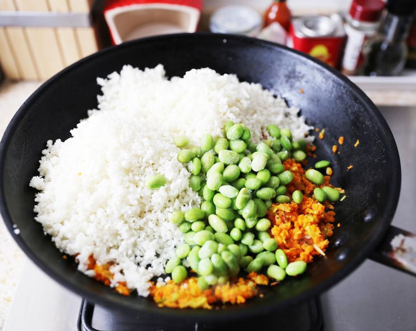 step 4 Add the cauli rice and Edamame (1/4 cup) beans and stir fry quickly for around 3 minutes.