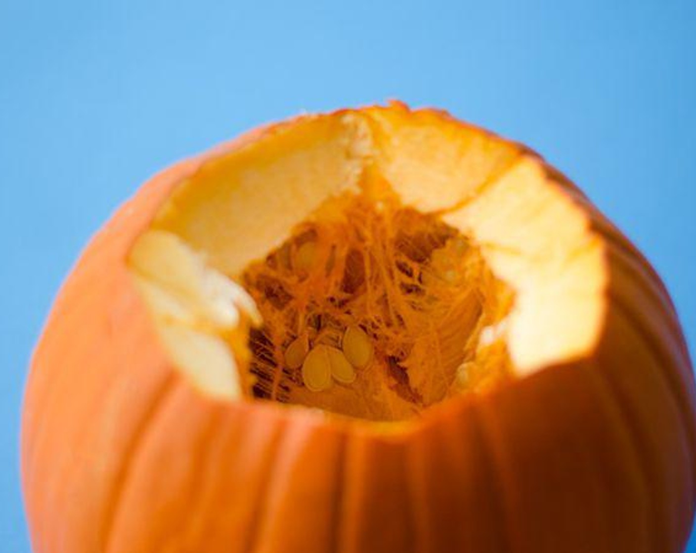 step 1 For small pumpkins, chop off top, cut in half, and remove seeds. For larger pumpkins, cut around stem, remove seeds, and cut 4 inch-ish wide pieces down along the natural grooves. Gently scrape the inside with a spoon to remove the stringy gunk.