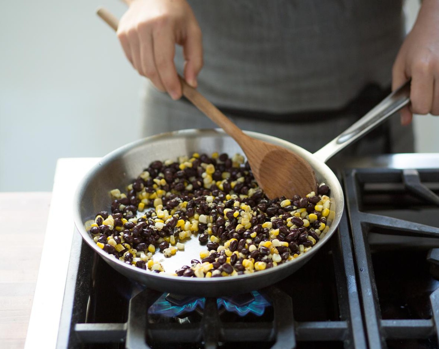 step 9 Heat a medium sauté pan over high heat and add Olive Oil (1 Tbsp). When the oil is hot, add the corn and sauté for 3 to 5 minutes; until golden brown.