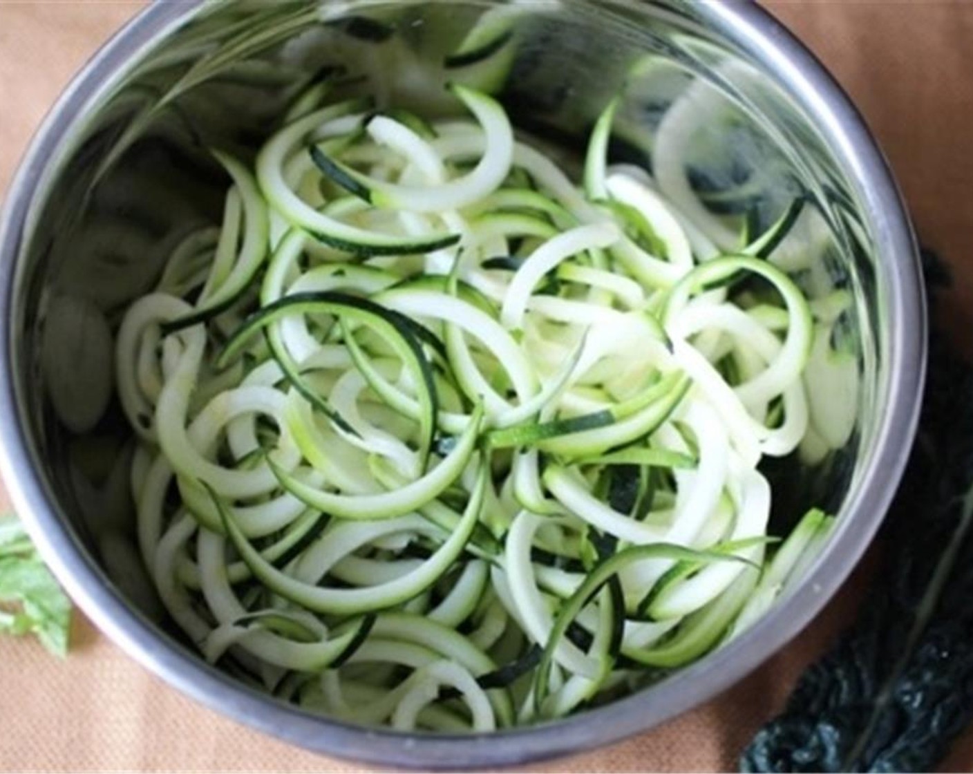 step 1 Spiralize or julienne the Zucchini (2). Add a small amount of Salt (to taste) and let them sit in a colander while you make the pesto. This will help them “sweat” a little and keep the pesto from turning runny after you dress the zucchini with it.