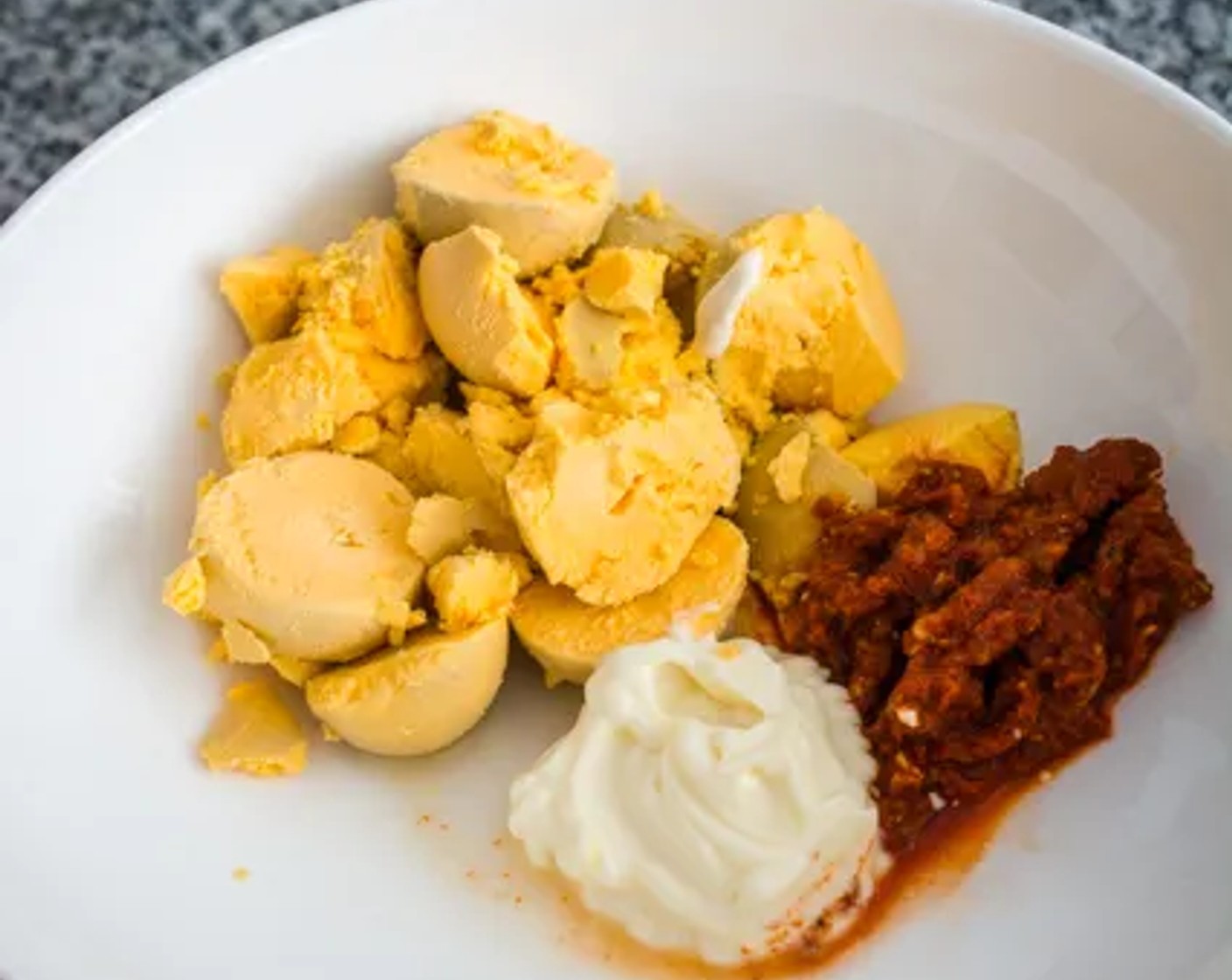 step 6 Place the egg yolks in a medium-sized mixing bowl. Add the Mayonnaise (2 Tbsp), Coconut Oil (1 Tbsp), Thai Red Curry Paste (1 Tbsp), 2 tsp of Lime (1), Salt (to taste), and Ground Black Pepper (to taste).