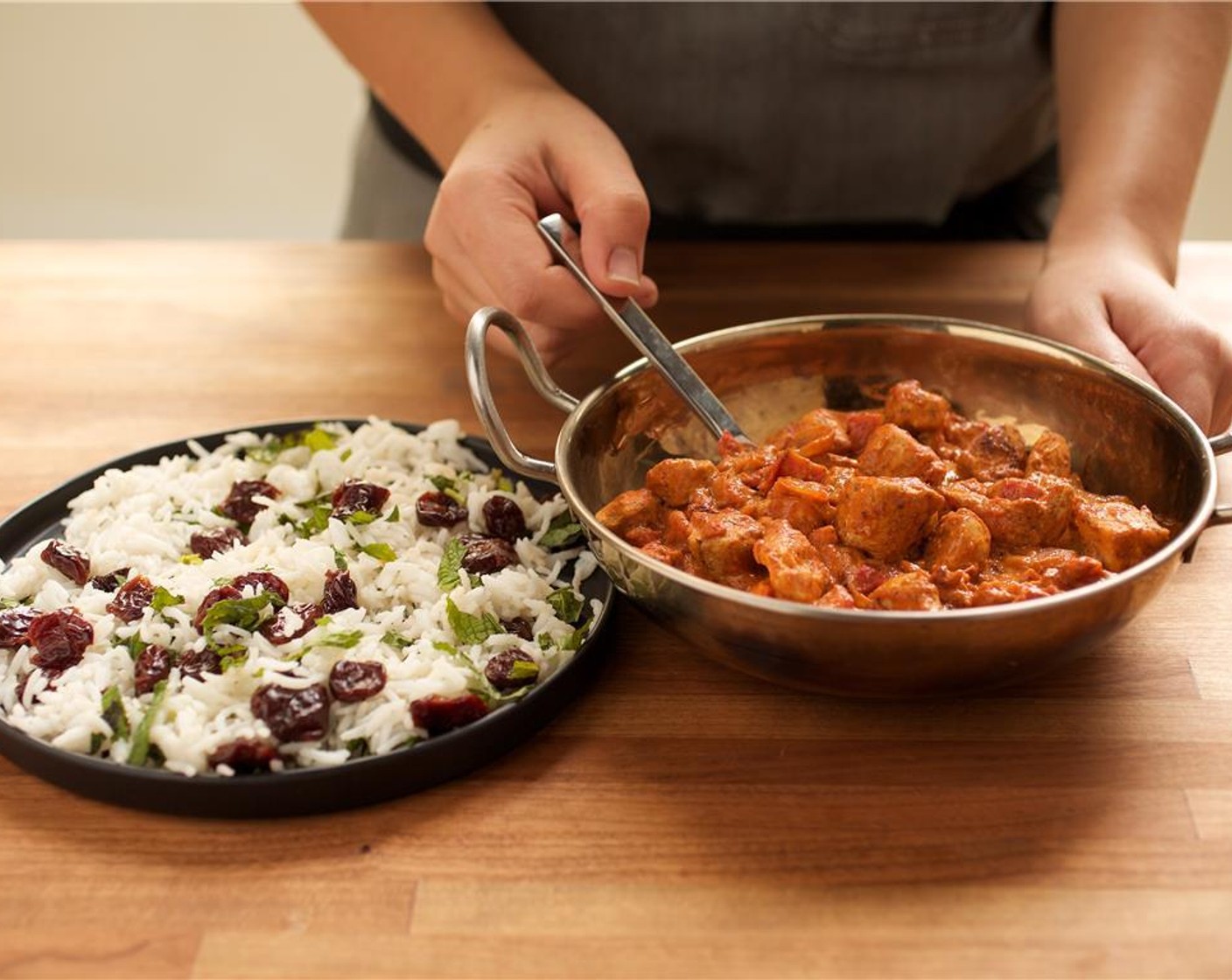 step 14 Place the curried coconut chicken in the center of two bowls. Place the basmati rice on a side plate.