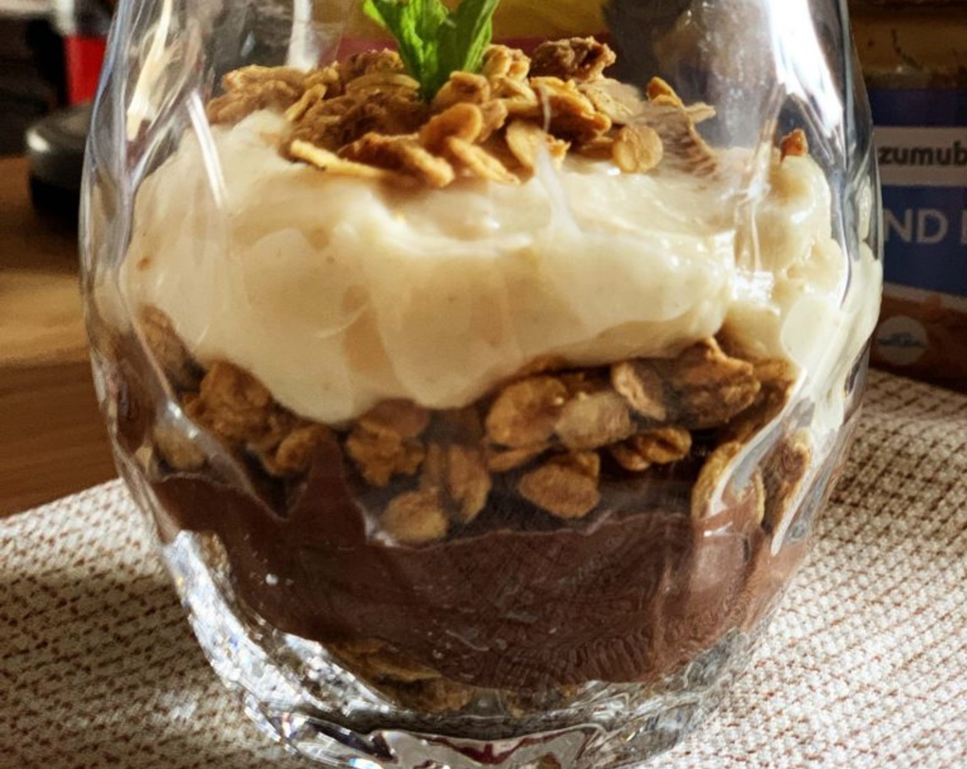 step 9 Next, to assemble your parfait, just lay some granola at the bottom of your container, cover it with a layer of chocolate custard, then place more granola, next is lemon custard. Decorate the top with some more granola or a dusting of cinnamon if you like!